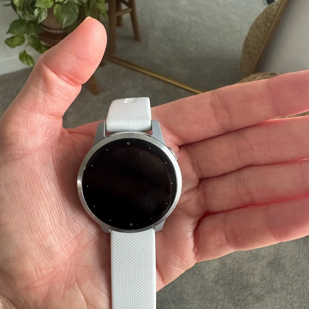 garmin vivoactive 4s white smartwatch with black charger cable